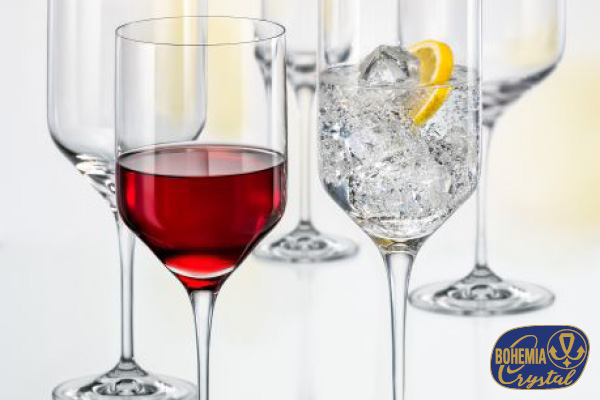 view of a coastal Mediterranean village on a hillside, with small boats in the water.